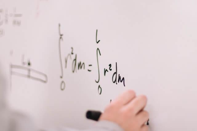 person writing on whiteboard